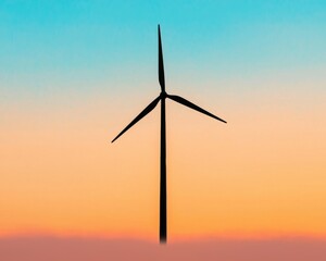 Obraz premium A silhouetted wind turbine stands against a vibrant sunset, symbolizing renewable energy and environmental sustainability.