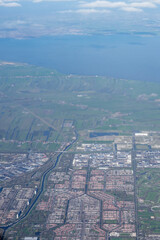 Netherlands, Holland, Dutch,  Aerial view of city outskirts in the day from an aeroplane window