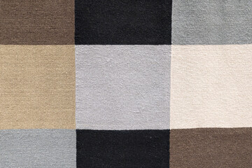 Fototapeta premium Neutral Toned Woven Fabric Checkerboard Pattern. textured woven fabric featuring a checkerboard pattern in neutral tones including beige, taupe, gray, black, and cream.