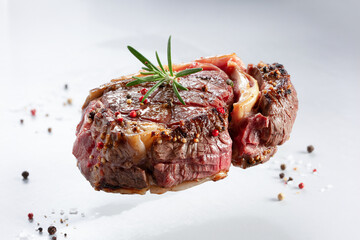 Juicy Ribeye Steak With Rosemary And Spices On A White Background Studio Shot