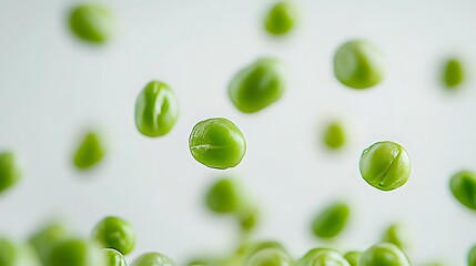 Fototapeta premium Fresh green peas floating on white background with split pea pod and glossy surface in macro photography