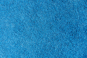 An eye-catching bright blue surface featuring a textured finish, suitable for recreational areas,...