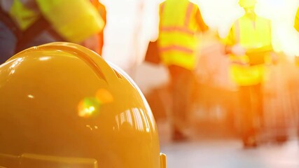 A vibrant scene showcasing construction workers in safety gear, including hard hats and reflective vests. They collaborate on-site, emphasizing safety and teamwork.
