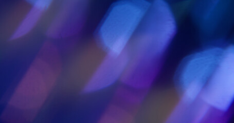 Gleam shiny. Blur abstract lens. Defocused purple blue glint light flare texture on modern optical art dark black background.