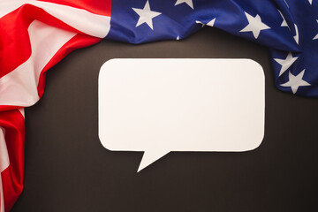 Blank speech bubble with the American flag on a dark background.