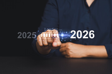 Close-up of hand touching animated loading bar moving from 2025 to 2026.