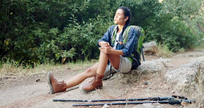 Woman, nature or injury on knee with hiking, joint dislocation or fall with stress in pain. Female hiker, fitness or break on trekking trail with leg emergency, accident or torn ligament in woods