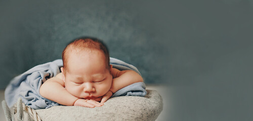 A newborn baby is wrapped in diapers with a wool cap in a basket. Swaddling, maternity hospital, family, ivf, life planning, parenting. A mother's love for her child. Baby food. High quality photo