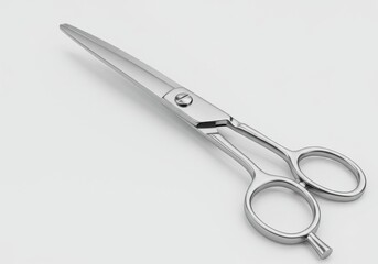 Obraz premium A pair of silver metal scissors lying diagonally on a white surface with a simple background
