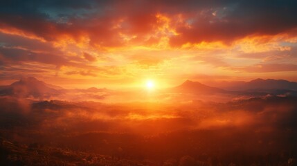 Fototapeta premium A breathtaking sunset illuminating a mountainous landscape, showcasing vibrant colors and mist, creating a serene and tranquil atmosphere.