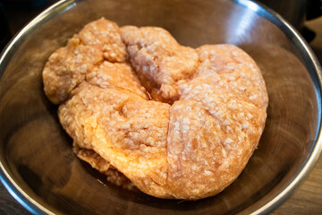 Minced chicken in a metal bowl close-up
