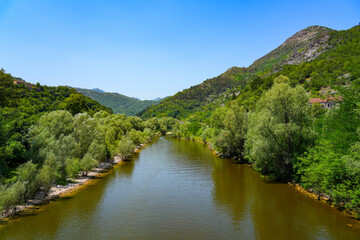 Obraz premium River Rijeka Crnojevića (River of Crnojević) flowing in the mountains near the Lake Skadar in Montenegro