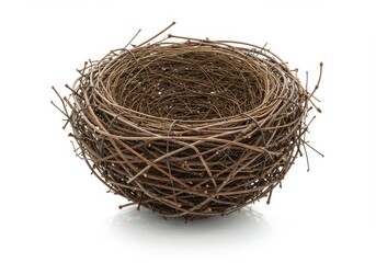 Obraz premium A bird's nest made of twigs and branches is isolated on a white background in a studio shot