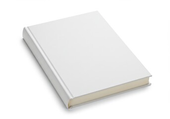 Fototapeta premium A blank white hardcover book lying flat on a white surface in a studio setting for mockup template use