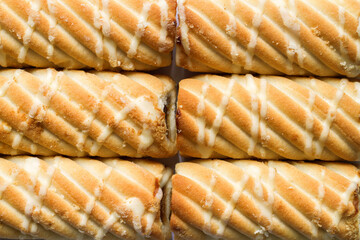 The texture of fresh natural rolls. Sweet bakery products close-up. Cookies with filling.