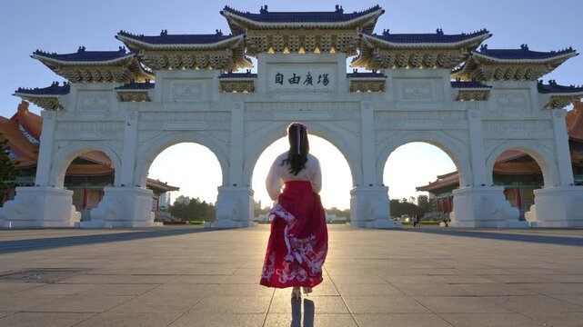 4k Slow motion video, Chiang Kai Shek Memorial Arch with morning sunlight and Asian women in Taipei, Taiwan.