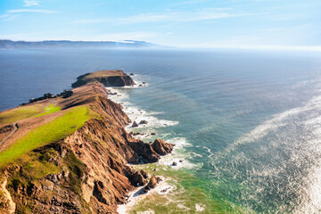 Breathtaking aerial view of Point Reyes, California, showcasing dramatic coastal cliffs surrounded by the Pacific Ocean. A stunning destination for nature lovers, photographers, and outdoor