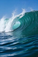 surfer riding a large wave in the ocean on a sunny day