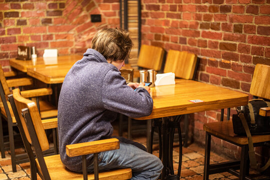 teenage boy makes an order by QR code in a cafe