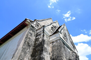 Closeup of The Part of an old abandoned temple with only bricks and cement remaining, which had been abandoned for a long time in the forest background at Thailand.