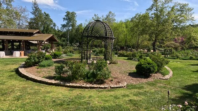 footage of a gorgeous spring landscape with a gazebo, colorful flowers and lush green trees and plants at Descanso Gardens La Canada Flintridge California USA