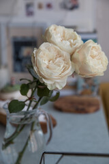 Bouquet of beige peony roses in the interior