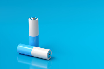 Two batteries lying on a blue background representing sustainable energy storage