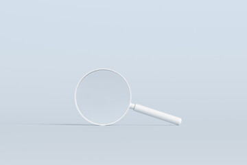 White magnifying glass lying on pastel blue background