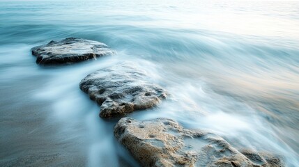 Obraz premium Serene Coastal Scene with Gentle Waves and Rocky Shoreline