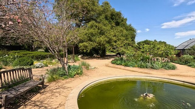 footage of a water fountain with lush green trees and plants and colorful flowers at Descanso Gardens La Canada Flintridge California USA