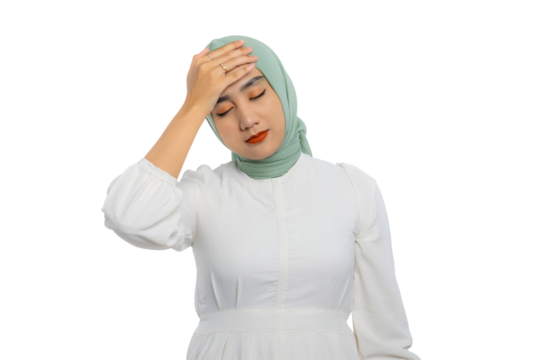 Stressed young Asian woman in green hijab and white blouse touching her forehead in frustration isolated on transparent background