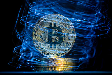 Bitcoin cryptocurrency coin hovering over a stack of coins with futuristic blue lights emanating from the surface, creating a dynamic visual representation of digital finance and investment