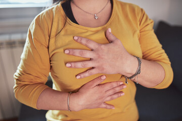 Woman with strong stomach ache, menstrual and digestive issues at home.