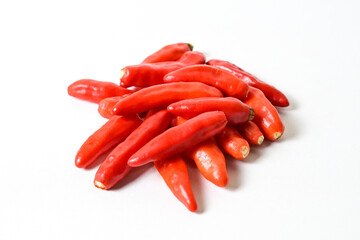 Close up view of fresh red chili peppers isolated on white background. Clipping path. Pile, stack. 