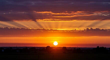 Fototapeta premium Fiery Sunset Landscape: Sunbeams Burst Through Clouds