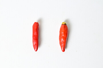 Top view of two (2) fresh red chili peppers isolated on white background. Clipping path. Close up. High angle, above.
