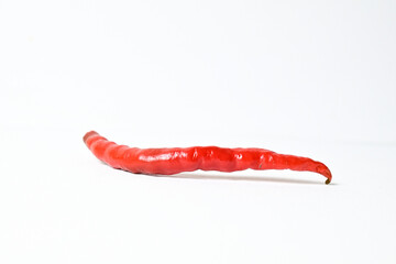 Close up view of one (1) fresh red chili pepper isolated on white background. Clipping path. Side view.