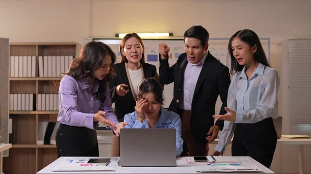 Corporate professional experiencing intense workplace tension, blaming colleague for critical error during high-pressure office meeting near laptop computer
