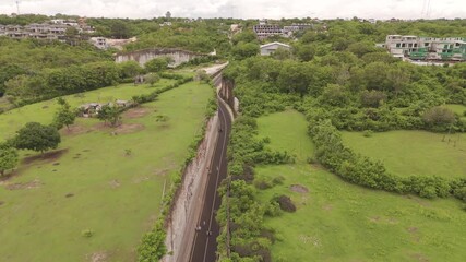 Aerial View of Narrow Road Carving Through Valley at Tanah Barak, Bali – Stunning Drone Footage of Unique Cliff Passage and Scenic Landscape in Indonesia