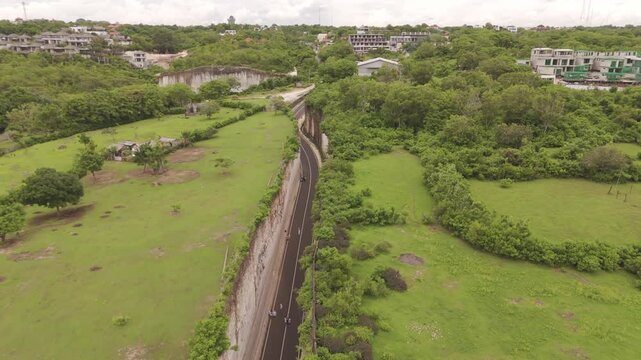 Aerial View of Narrow Road Carving Through Valley at Tanah Barak, Bali &ndash; Stunning Drone Footage of Unique Cliff Passage and Scenic Landscape in Indonesia