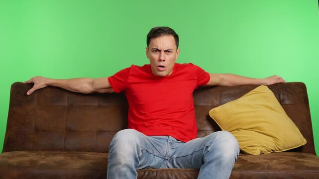 Man sitting on sofa changing position and falling asleep on green screen