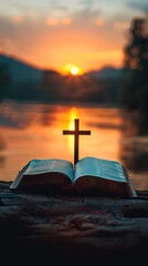 Open Bible with Cross at Sunrise over River