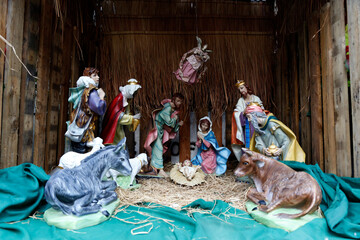 Statuettes of Mary, Joseph and baby Jesus,The birthday of Jesus is a statuette of Maria with Joseph and newborn Jesus on the hay, A Christmas nativity scene.