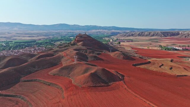 drone shot of hill with statue and city in summer aragon spain