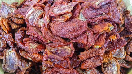 Sun-dried tomatoes are piled high, showcasing their rich color and texture, ready to enhance various dishes