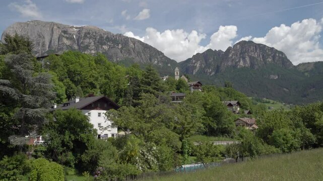 View of part of the village of Voels am Schlern - Fi&egrave; allo Sciliar, South Tyrol, Italy on a sunny day in spring. Mountains are in the background.