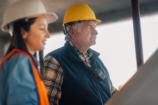 Construction workers observing building progress on site