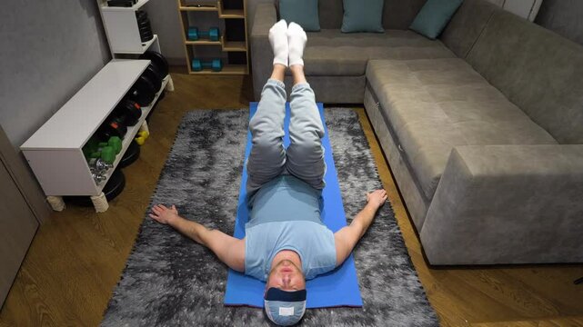 Exercise for the prostate and male potency Kegel. Male Pilates or yoga in the apartment. Workout on a fitness mat at home in the room. Warm-up warming up muscles. Slow motion.