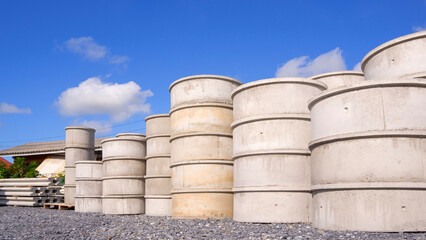 Group of concrete well rings with different diameters stacked on the ground outside of hardware store