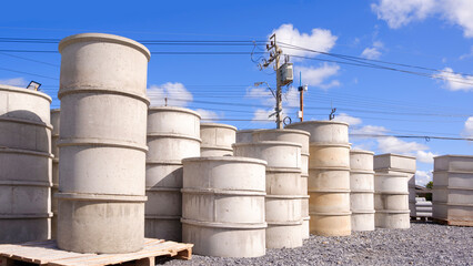 Group of concrete well rings with different diameters stacked on the ground outside of hardware store